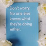 blue card surrounded with flowers