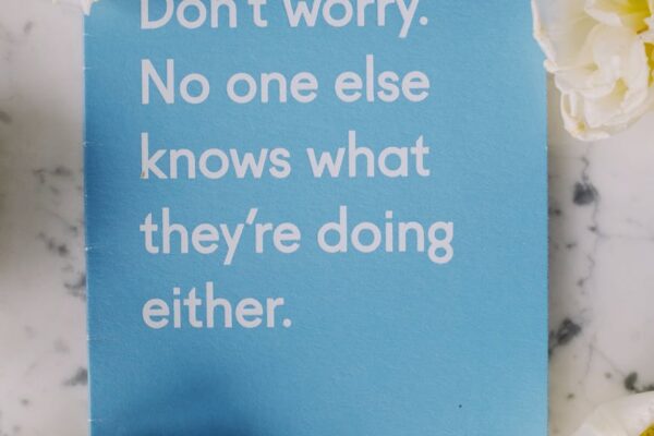 Extraordinary Quotes blue card surrounded with flowers